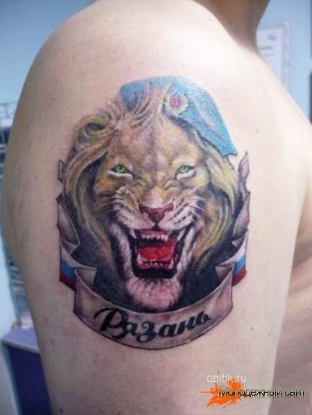 Цветная татуировка на плече льва в берете